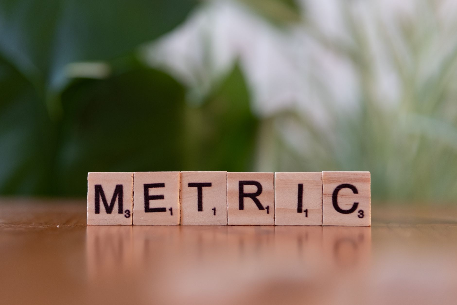 wooden tiles spelling metric on table surface